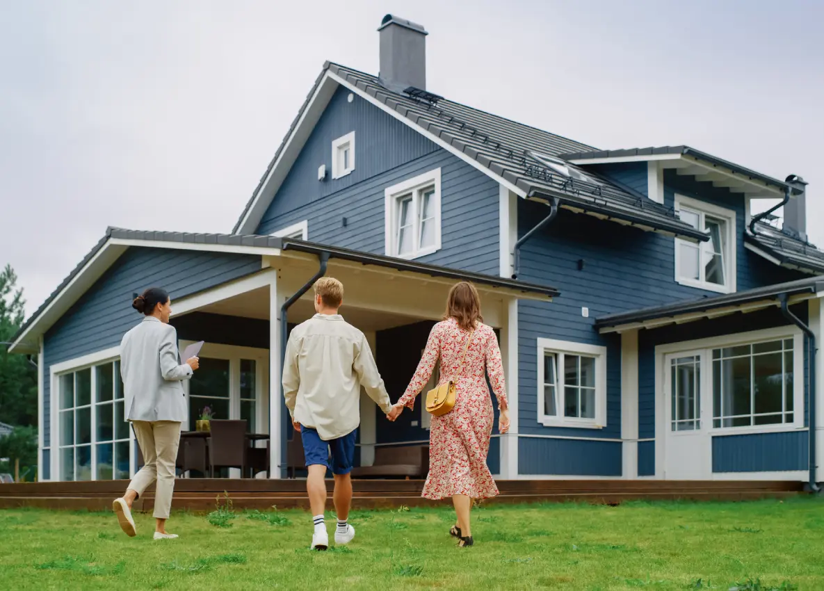 People walking towards a blue house.